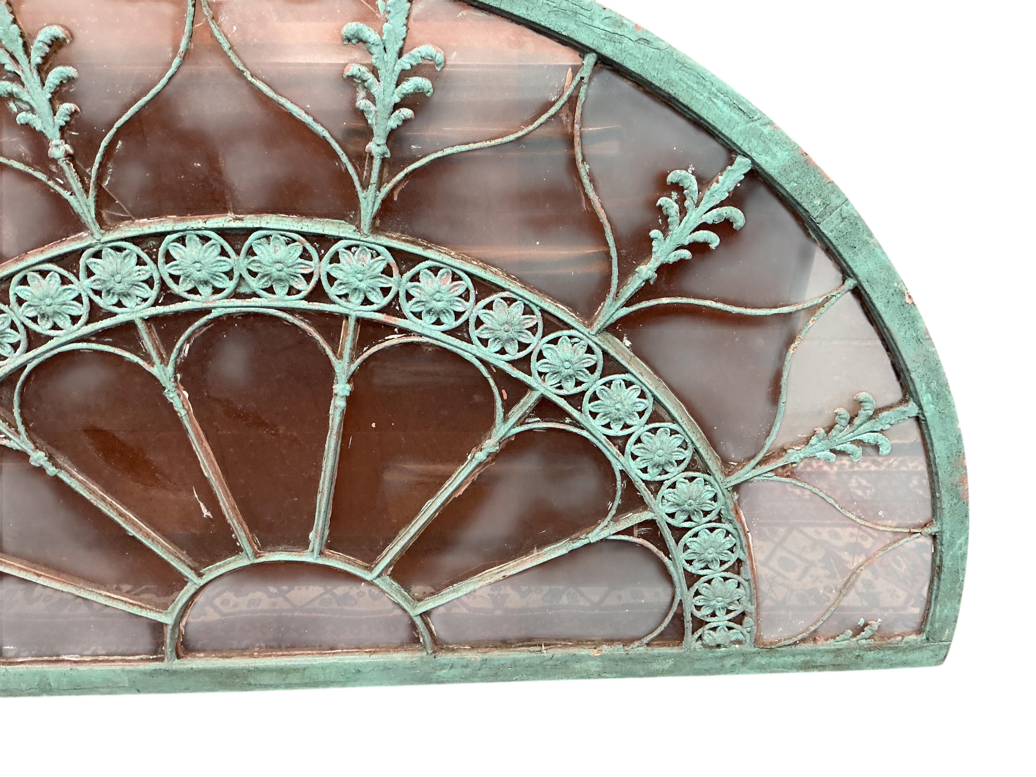 A 19th century wood and wrought iron fan light, later painted, width 170cm, height 91cm